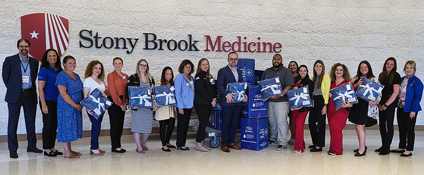 Cancer center staff accepting donation from Subaru