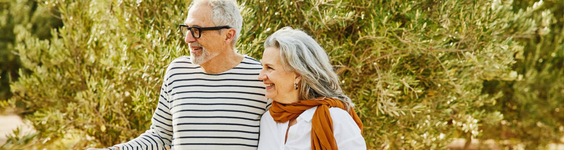 Smiling older couple walking outdoors