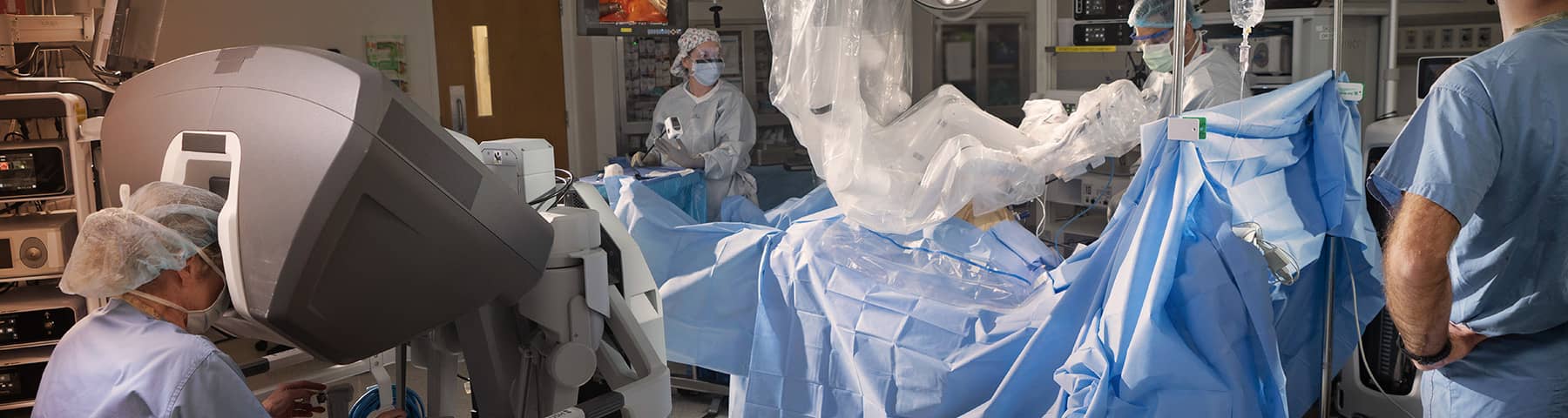 Surgical team performing robotic-assisted surgery in a hospital operating room.