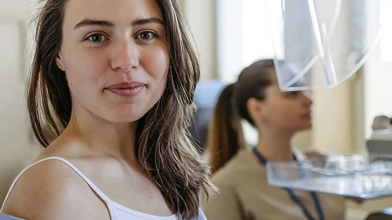 Woman preparing for a mammogram.