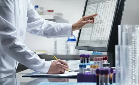 A doctor looking at data on a screen