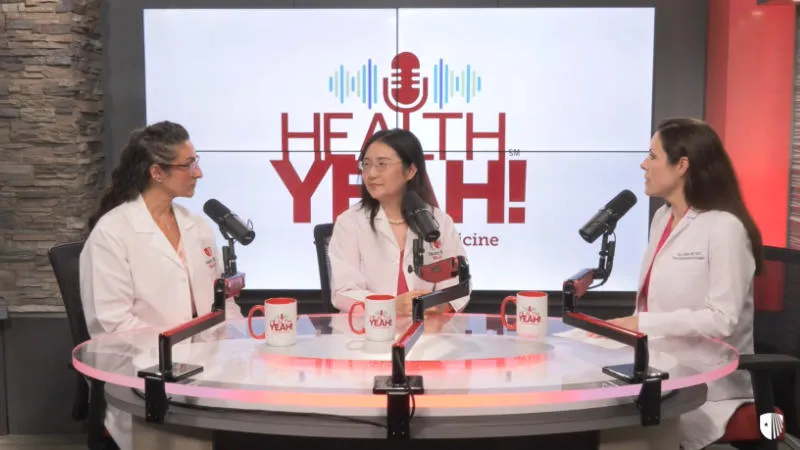 Doctors at a table recording a podcast.