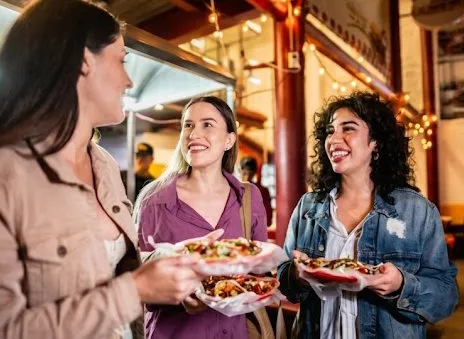 Friends eating and laughing at a restaurant