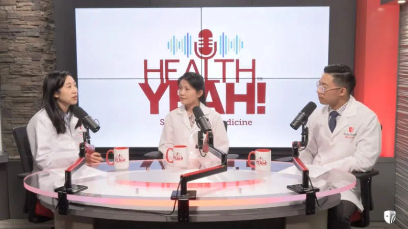 Doctor’s recording a podcast at a table.